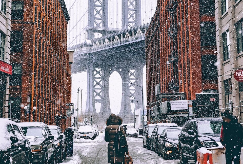 woman facing towards Brooklyn Bridge in New York