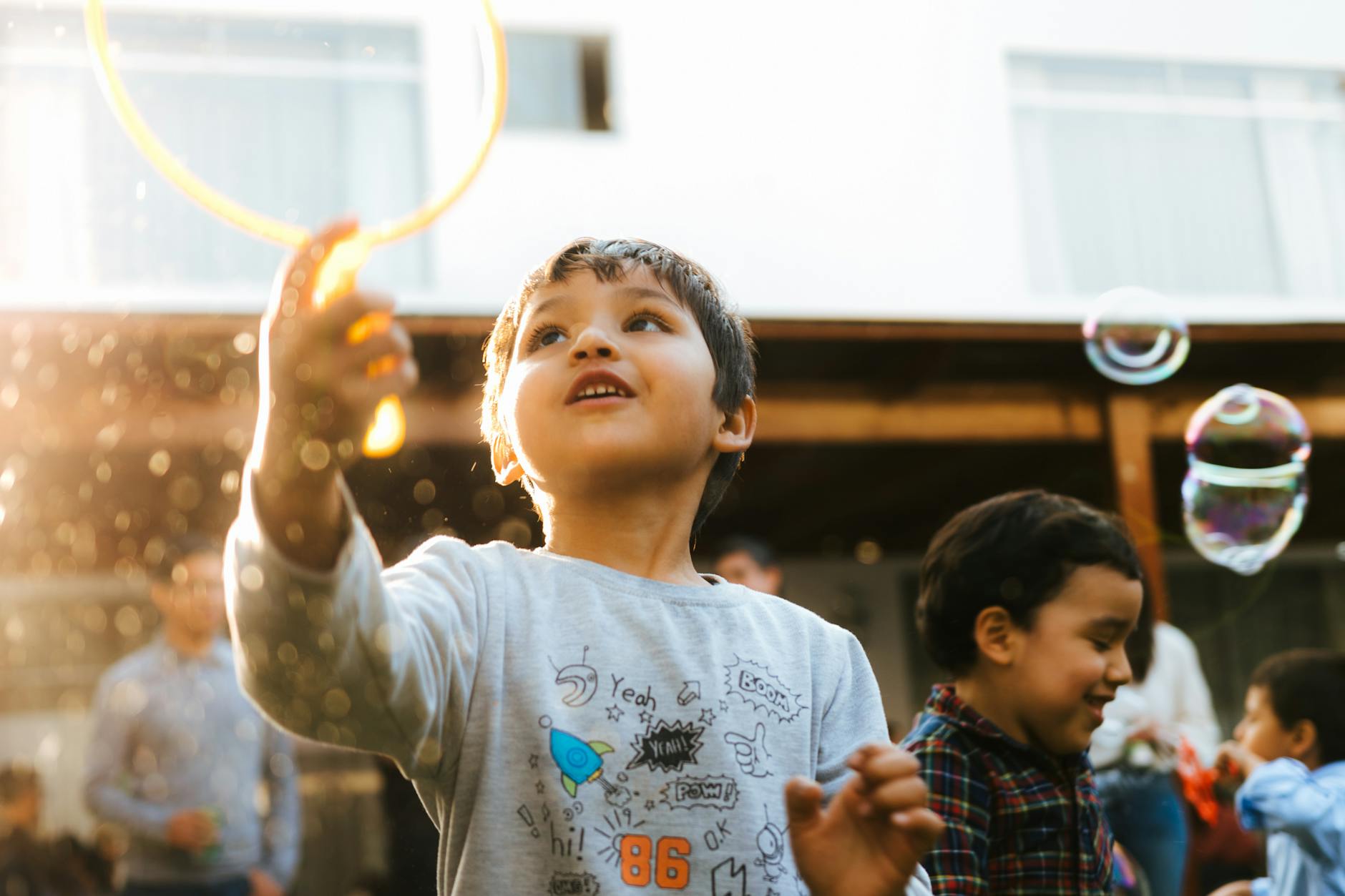 a little boy playing with a bubble